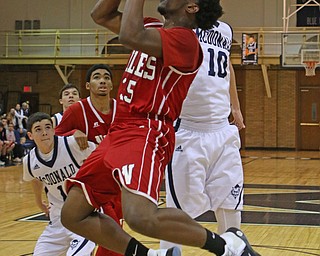 Tyreece Williams (35) of Niles goes up for a shot while being defended by McDonald's Evan Magill (10) during the second quarter of Friday nights matchup at McDonald High School.  Dustin Livesay  |  The Vindicator  12/30/16  McDonald.