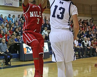 Jasson Faison (3) of Niles puts up a jump shot while being defended by Dylan Portuless (13) during the second quarter of Friday nights matchup at McDonald High School.  Dustin Livesay  |  The Vindicator  12/30/16  McDonald.