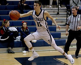 Caleb Emerson (11) of McDonald leaps to save the ball from going out of bounds during the second quarter of Friday nights matchup against Niles at McDonald High School.  Dustin Livesay  |  The Vindicator  12/30/16  McDonald.