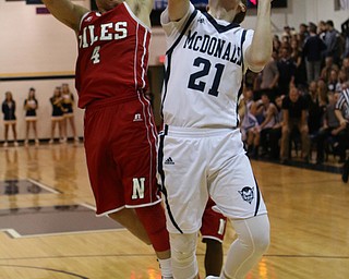 McDonald's Joe Ragozzin (21) goes up for a shot while being defended by Cyler Kane Johnson (4) of Niles during the second quarter of Friday nights matchup at McDonald High School.  Dustin Livesay  |  The Vindicator  12/30/16  McDonald.