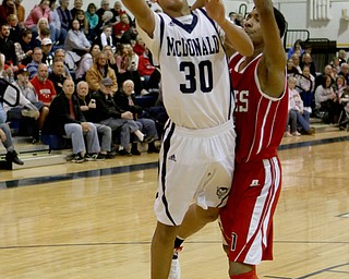Braedon Poole (30) puts up a layup while being defended by Donald Daniel (24) of Niles during the third quarter of Friday nights matchup against Niles High School at McDonald High School.  Dustin Livesay  |  The Vindicator  12/30/16  McDonald.