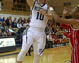 Evan Magill (10) of McDonald puts up a layup while being defended by Jasson Faison (3) during the third quarter of Friday nights matchup at McDonald High School.  Dustin Livesay  |  The Vindicator  12/30/16  McDonald.