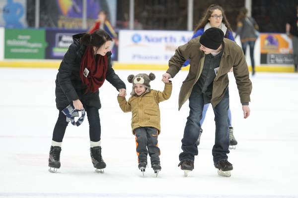 (from left) Thomas and Rachel Clunen of Girard help their son, Gabriel(3) ice skate during First Night Youngstown at the the Covelli Centre in Youngstown on Saturday, Dec. 31, 2016...(Nikos Frazier | The Vindicator)..