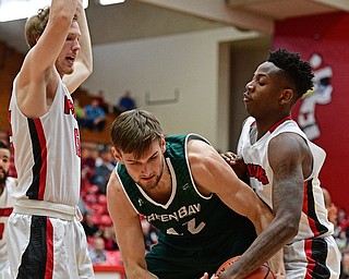 YOUNGSTOWN, OHIO - DECEMBER 31, 2016: David Jesperson #42 of Green Bay wrestles for the basketball with Braun Hartfield #1 of YSU while being guarded by Brett Frantz #15 during the second half of their game Saturday afternoon at Beeghly Center. DAVID DERMER | THE VINDICATOR