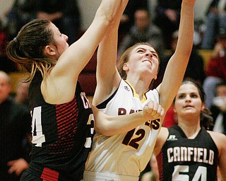  William D. Lewis The Vindicator South Range's Rachel Maynard (12) shoots between Canfield's Brittany Coonce(34) Serena Sammarone(54)and during 1-2-17 action at South Range.