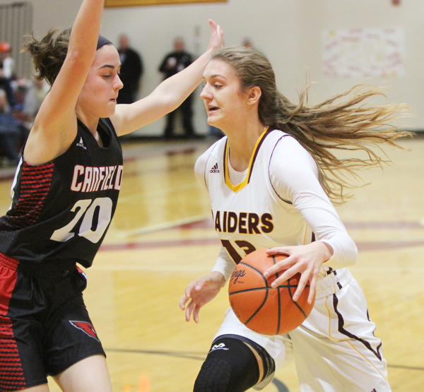  William D. Lewis The vindicatorSouth Range's Maddie Durkin(13) drives around Canfield's Alexandra Stanic(20)  during 1-2-17 action at South Range.