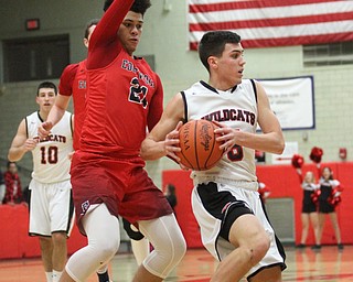 Struthers guard Andrew Carbon(5) dodges a defender as he looks for an open teammate as Edgewood Brevin White(21) looms close behind during the first quarter as The Struthers Wildcats takes on the Edgewood Warriors at the Struthers High School Fieldhouse in Struthers on Tuesday, Jan. 3, 2017. Struthers won, 55-45...(Nikos Frazier | The Vindicator)..