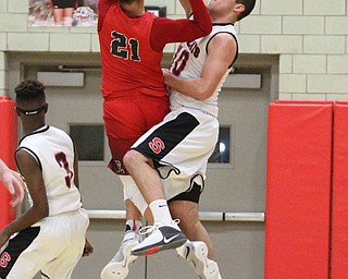 Struthers forward AJ Musolino(10) attempts to block Edgewood Brevin White(21) layup during the first quarter as The Struthers Wildcats takes on the Edgewood Warriors at the Struthers High School Field house in Struthers on Tuesday, Jan. 3, 2017. Struthers won, 55-45...(Nikos Frazier | The Vindicator)..