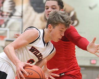 Struthers guard Carson Ryan(2) collides with a Edgewood defender during the third quarter as The Struthers Wildcats takes on the Edgewood Warriors at the Struthers High School Fieldhouse in Struthers on Tuesday, Jan. 3, 2017. Struthers won, 55-45...(Nikos Frazier | The Vindicator)..