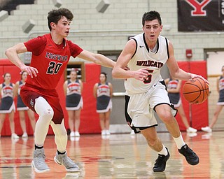 Struthers guard Andrew Carbon(5) charges towards the basket pursued by Edgewood Hayden Kanicki(20) during the third quarter as The Struthers Wildcats takes on the Edgewood Warriors at the Struthers High School Fieldhouse in Struthers on Tuesday, Jan. 3, 2017. Struthers won, 55-45...(Nikos Frazier | The Vindicator)..