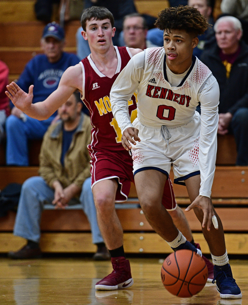 WARREN, OHIO - JANUARY 3, 2017: Hyland Burton #0 of JFK drives down the baseline in front of Pat Brennan #14 of Mooney during the first half of their game Tuesday night at John F. Kennedy High School. DAVID DERMER | THE VINDICATOR