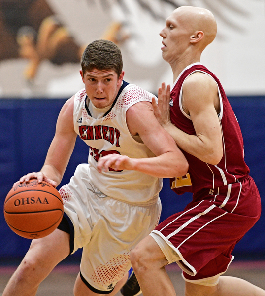 WARREN, OHIO - JANUARY 3, 2017: Justin Bofenkamp #33 of JFK drives on Johnnie Mikos #12 of Mooney during the first half of their game Tuesday night at John F. Kennedy High School. DAVID DERMER | THE VINDICATOR