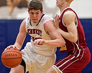 WARREN, OHIO - JANUARY 3, 2017: Justin Bofenkamp #33 of JFK drives on Johnnie Mikos #12 of Mooney during the first half of their game Tuesday night at John F. Kennedy High School. DAVID DERMER | THE VINDICATOR