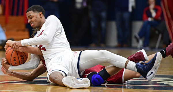 WARREN, OHIO - JANUARY 3, 2017: Byron Taylor #5 of JFK and Jay Raymer #3 of Mooney wrestle for the basketball at mid-court during the first half of their game Tuesday night at John F. Kennedy High School. DAVID DERMER | THE VINDICATOR