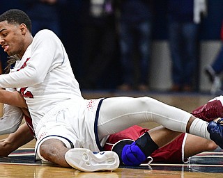 WARREN, OHIO - JANUARY 3, 2017: Byron Taylor #5 of JFK and Jay Raymer #3 of Mooney wrestle for the basketball at mid-court during the first half of their game Tuesday night at John F. Kennedy High School. DAVID DERMER | THE VINDICATOR
