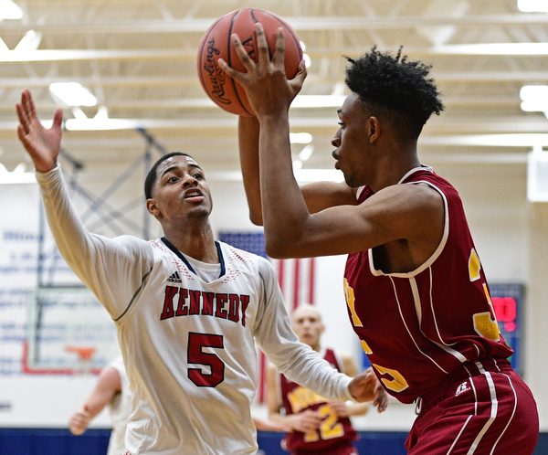 WARREN, OHIO - JANUARY 3, 2017: Byron Taylor #5 of JFK pressures Jordan Stanford #35 of Mooney as he looks to pass the basketball during the first half of their game Tuesday night at John F. Kennedy High School. DAVID DERMER | THE VINDICATOR