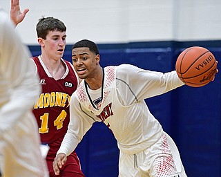 WARREN, OHIO - JANUARY 3, 2017: Byron Taylor #5 of JFK attempts to dribble up court while ebbing held by Pat Brennan #14 of Mooney during the first half of their game Tuesday night at John F. Kennedy High School. DAVID DERMER | THE VINDICATOR