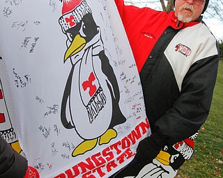        ROBERT K. YOSAY  | THE VINDICATOR..YSU alum andbig fan with his banner signed by current YSU players Harold Wilson ready to urge on his penguins and will be joining them in Frisco..YSU Fans  gathered at Youngstown State University to  send off the Penguins to the FCS National Championship in Frisco, Texas against James Madison University. - ...- -30-...