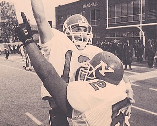 YSU QB Mark Brungard gets a lift from teammate Brian White as the pair celebrate the penguins second NCAA Div 1-AA National Championship in the last three years. Dec. 18, 1993 Bob DeMay | The Vindicator File Photo
