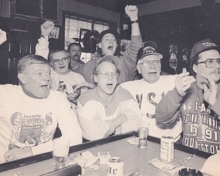 A CROWD OF YSU FANS AT IRISH BOB'S PUB ON SOUTH AVENUE INCLUDING TOM FORAN, ROB FARDNER, CLEM SIEMBIEDA, BAB VRABLE, MARK SICUFSE AND JIM POWERS CELEBRATE AN EDIVENT YSU VICTORY OVER MARSHALL UNIVERSITY. BOB CHRISTY | THE VINDICATOR FILE PHOTO
