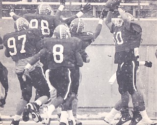YOUNGSTOWN STATE LINEBACKER LEON JONES #50 CELEBRATES WITH HIS TEAMMATES AFTER PICKING UP A FUMLE AND RETURNING IT 42 YARDS FOR THE PENGUINS FIRST TOUCHDOWN AGAINST THE UNIVERSITY OF IDAHO IN THE NCAA DIV 1-AA SEMI-FINALS LAST WEEK AT STAMBAUGH STADIUM  Bob DeMay | The Vindicator File Photo
