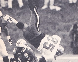 YSU'S TAMRON SMITH IS FLIPPED IN THE AIR BY MARSHALL'S WILLIAM KING #3 IN THE SECOND QUARTER Dec. 18, 1993 Bob DeMay | The Vindicator File Photo