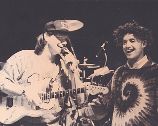 YSU FOOTBALL COACH HIM TRESSEL JOINS FABOULOUS FLASHBACK BRIAN MCCALL ON STAGE FOR A RENDITION OF "HANG ON SLOOPY" DURING A CELEBREATION FRO THE NATIONAL CHAMPS AT TBEEGHLEY CENTER SUNDAY. TRESSELL DONNED THE WIG AND TIE DYE SHIRT AS PART OF THE ACT. JAN. 16, 1994. WILLIAM D. LEWIS | THE VINDICATOR FILE PHOTO