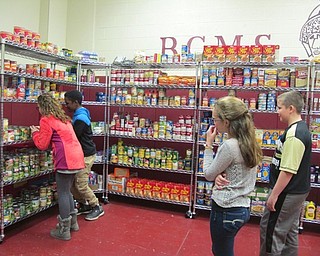 Neighbors | Alexis Bartolomucci.Students at Boardman Center Intermediate School looked through the food items at the pantry on Nov. 29.
