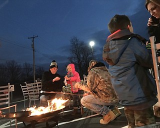 Neighbors | Alexis Bartolomucci.Guests at the Austintown Dairy Queen Christmas event on Dec. 10 roasted marshmallows over the fire.