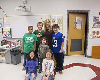 Neighbors | Alexis Bartolomucci.Candace Monecelli stood with some of the fourth-grade students at Robinwood Lane Elementary on Dec. 8 after talking to them about weather and her job as a meteorologist.