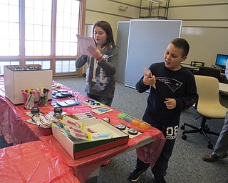 Neighbors | Alexis Bartolomucci.Students looked at different items to purchase during Santa's Workshop at Dobbins Elementary on Dec. 14.