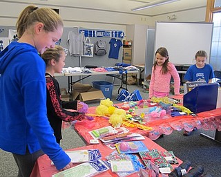Neighbors | Alexis Bartolomucci.Fourth-grade Dobbins students picked out gifts during Santa's Workship for holiday gifts on Dec. 14.