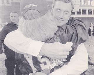 YSU HEAD COACH JIM TRESSELL EMBRACES A FAN AFTER THE PENGUINS WIN. BRUCE DEMAY | THE VINDICATOR FILE PHOTO