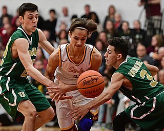 YOUNGSTOWN, OHIO - JANUARY 6, 2016: Alex Wollet #3 of Mooney has the ball knocked out of his hands by Anise Algahmee #3 of Ursuline while being pressured by Vince Venzeio #22 during the first half of their game Friday night at Cardinal Mooney High School. DAVID DERMER | THE VINDICATOR