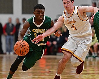 YOUNGSTOWN, OHIO - JANUARY 6, 2016: Dakota Hobbs #14 of Ursuline drives on Jay Raymer #4 of Mooney during the second half of their game Friday night at Cardinal Mooney High School. DAVID DERMER | THE VINDICATOR