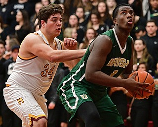 YOUNGSTOWN, OHIO - JANUARY 6, 2016: Anthony Howell #1 of Ursuline goes to the basket while being pressured by Vinny Gentile #34 of Mooney during the second half of their game Friday night at Cardinal Mooney High School. DAVID DERMER | THE VINDICATOR