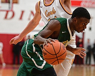 YOUNGSTOWN, OHIO - JANUARY 6, 2016: Dakota Hobbs #14 of Ursuline drives on Pat Brennan #14 of Mooney during the second half of their game Friday night at Cardinal Mooney High School. DAVID DERMER | THE VINDICATOR