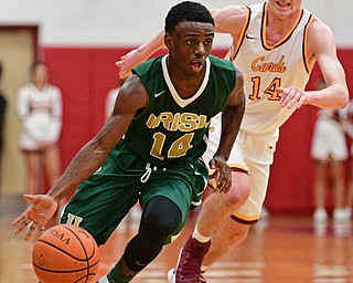 YOUNGSTOWN, OHIO - JANUARY 6, 2016: Dakota Hobbs #14 of Ursuline drives on Pat Brennan #14 of Mooney during the second half of their game Friday night at Cardinal Mooney High School. DAVID DERMER | THE VINDICATOR