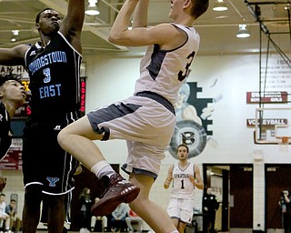 Boardman's Holden Lipke (3) goes up for a shot while being blocked by Youngstown East's Vonzell Matlock (3) during the first half of Friday nights matchup at Boardman High School.  Dustin Livesay  | The Vindicator  1/6/17   Boardman