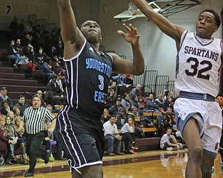 Vonzell Matlock (3) of East goes up for a layup while being defended by Boardman's Che Trevena (32) during the first half of Friday nights matchup at Boardman High School.  Dustin Livesay  | The Vindicator  1/6/17   Boardman