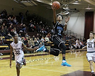 Terrell Weaver (10) of Youngstown East goes up for a layup while being defended by Boardman's Sebastian Heinonen (21) and Che Trevena during the first half of Friday nights matchup at Boardman High School.  Dustin Livesay  | The Vindicator  1/6/17   Boardman