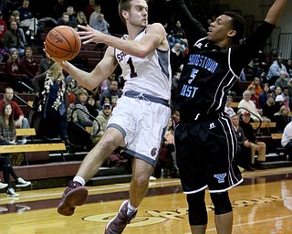 Boardman's John Ryan (1) looks to pass while being defended by Youngstown East's Ce'andre Backus (5) during the second half of Friday nights matchup at Boardman High School.  Dustin Livesay  | The Vindicator  1/6/17   Boardman