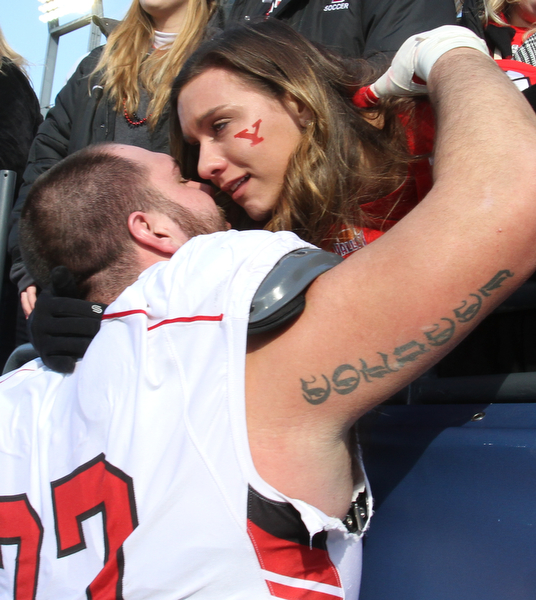 William D Lewis The Vindicator YSU's Dylan Colucci(77) gets hug from his gitlfriend Amanda Clucas of Cleveland afterplayoff loss.