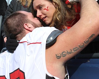 William D Lewis The Vindicator YSU's Dylan Colucci(77) gets hug from his gitlfriend Amanda Clucas of Cleveland afterplayoff loss.