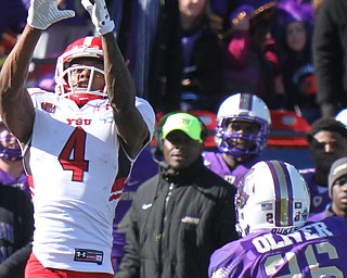 William D Lewis The Vindicator YSU's Damoun Pattewson(4) pulls in a pass past JMU's Curtis Oliver(26).