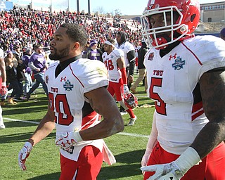 William D Lewis The Vindicator YSUJody Webb(20) and Alvin Biley(5) lsve the field after loss.