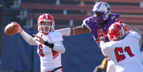 William D Lewis The Vindicator YSU's Hunter Wells eludes Darroiud Cater (47) while Justin Spencer (61) blocks.