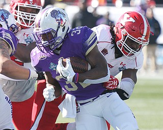 William D Lewis the Vindicator JMU's Kahlid Abudullah (32) eludes YSU's Avery Moss(9) during 1rst Qtr z\action