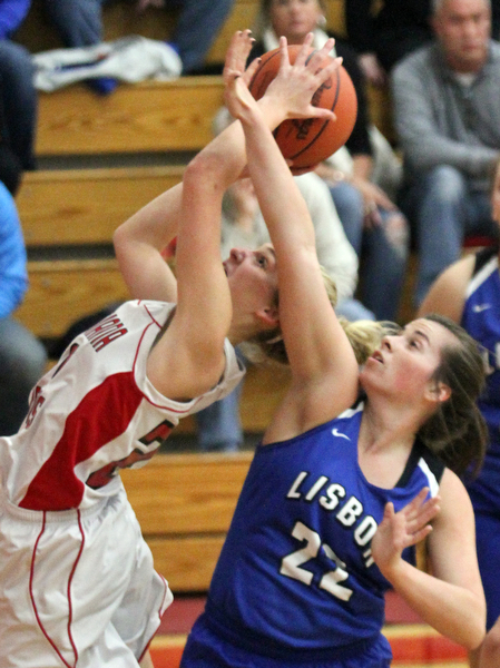 William D. Lewis The Vindicator  Columbiana's Alexis Cross(20) shots past Lisbon's Alexa Bell(22) duringJan. 9, 2017 action at Columbiana.