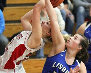 William D. Lewis The Vindicator  Columbiana's Alexis Cross(20) shots past Lisbon's Alexa Bell(22) duringJan. 9, 2017 action at Columbiana.